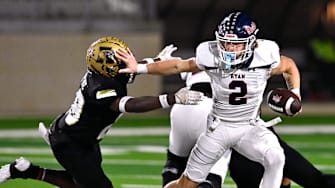 Denton Ryan QB Braeden Mussett pushes away Abilene's Dristain Paine during a 5A Division I playoff game on Nov. 17, 2023. 