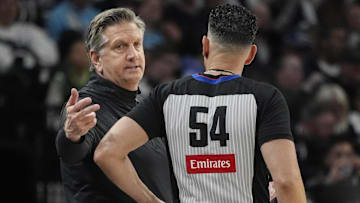 Apr 11, 2025; Minneapolis, Minnesota, USA; Minnesota Timberwolves head coach Chris Finch talks with referee Ray Acosta in the fourth quarter of the game with the Brooklyn Nets at Target Center. Mandatory Credit: Bruce Kluckhohn-Imagn Images