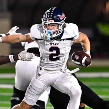 Denton Ryan QB Braeden Mussett pushes away Abilene's Dristain Paine during a 5A Division I playoff game on Nov. 17, 2023. 