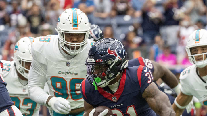 Aug 19, 2023; Houston, Texas, USA; Houston Texans running back Dameon Pierce (31) rushes against Miami Dolphins defensive tackle Brandon Pili (96) in the first quarter at NRG Stadium.