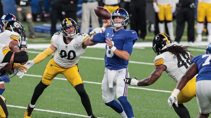 Sep 14, 2020; East Rutherford, New Jersey, USA; Pittsburgh Steelers outside linebacker T.J. Watt (90) grabs the arm of New York Giants quarterback Daniel Jones (8) during the first half at MetLife Stadium.  