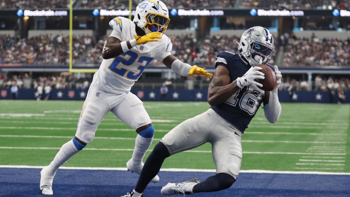 Aug 24, 2024; Arlington, Texas, USA; Dallas Cowboys wide receiver Ryan Flournoy (18) catches a touchdown pass against Los Angeles Chargers cornerback Matt Hankins (23)  in the second quarter at AT&T Stadium. 