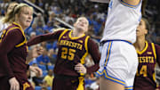 Feb 2, 2025; Los Angeles, California, USA; UCLA Bruins guard Gabriela Jaquez (11) scores between Minnesota Golden Gophers center Sophie Hart (52), Grace Grocholski (25) and Minnesota Golden Gophers forward Mallory Heyer (24) during the third quarter at Pauley Pavilion presented by Wescom. Mandatory Credit: Robert Hanashiro-Imagn Images