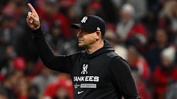Oct 15, 2022; Cleveland, Ohio, USA; New York Yankees manager Aaron Boone (17) signals for the bullpen against the Cleveland Guardians in the sixth inning during game three of the NLDS for the 2022 MLB Playoffs at Progressive Field. Mandatory Credit: Ken Blaze-Imagn Images