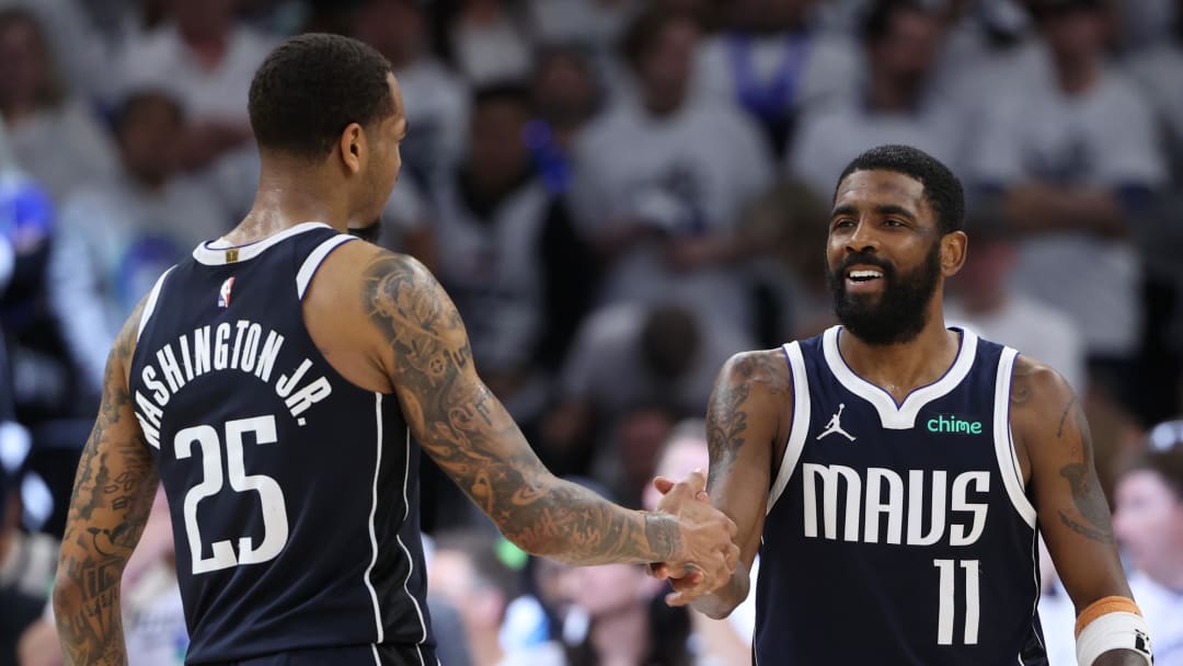 May 22, 2024; Minneapolis, Minnesota, USA; Dallas Mavericks guard Kyrie Irving (11) and forward P.J. Washington (25) celebrate after defeating the Minnesota Timberwolves in game one of the western conference finals for the 2024 NBA playoffs at Target Center. Mandatory Credit: Jesse Johnson-USA TODAY Sports