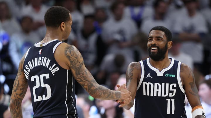 May 22, 2024; Minneapolis, Minnesota, USA; Dallas Mavericks guard Kyrie Irving (11) and forward P.J. Washington (25) celebrate after defeating the Minnesota Timberwolves in game one of the western conference finals for the 2024 NBA playoffs at Target Center. Mandatory Credit: Jesse Johnson-USA TODAY Sports