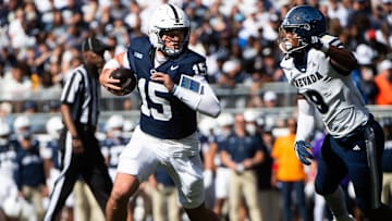 Penn State football quarterback Drew Allar runs with the ball in the first half against Nevada