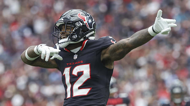 Texans wide receiver Nico Collins (12) signals after a first down 