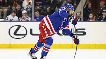 Mar 18, 2025; New York, New York, USA;  New York Rangers defenseman K'Andre Miller (79) attempts a shot on goal in the first period against the Calgary Flames at Madison Square Garden. 