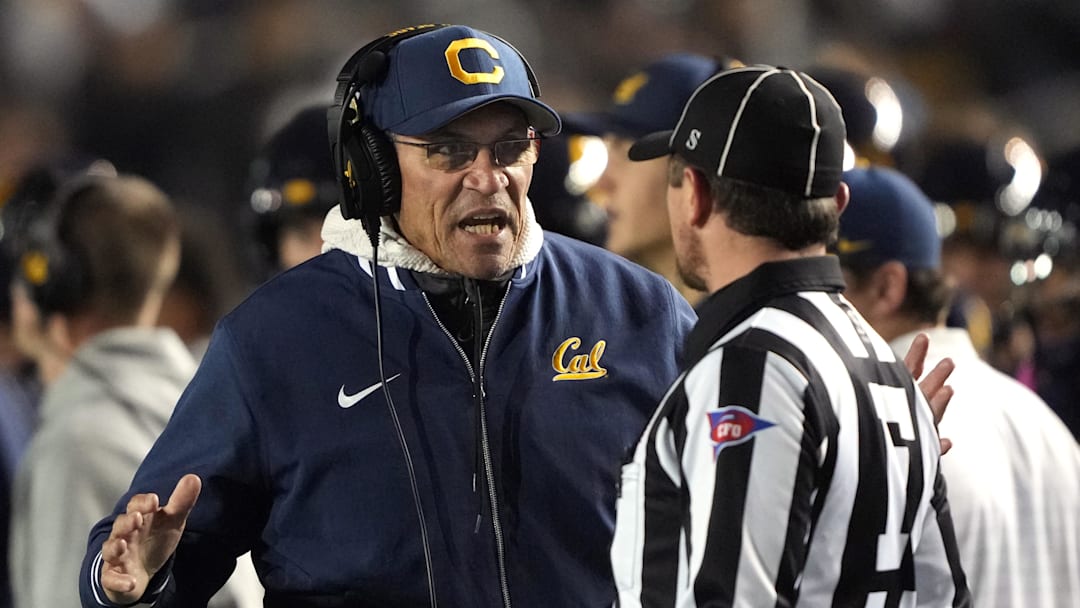 Nov 29, 2025; Berkeley, California, USA; California Golden Bears general manager Ron Rivera (left) talks with field judge Hugh Brown (right) during the third quarter against the Southern Methodist Mustangs at California Memorial Stadium. Mandatory Credit: Darren Yamashita-Imagn Images