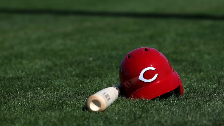 Cincinnati Reds third baseman Eugenio Suarez's (7) bat and helmet rest on the field.