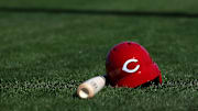 Cincinnati Reds third baseman Eugenio Suarez's (7) bat and helmet rest on the field, Thursday, Feb. 20, 2020, at the baseball team's spring training facility in Goodyear, Ariz.
