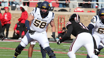 Nov 30, 2024; Lubbock, Texas, USA;  West Virginia Mountaineers offensive tackle Nick Malone (58) blocks Texas Tech Red Raiders defensive back Charles Esters III (11) in the second half at Jones AT&T Stadium and Cody Campbell Field. Mandatory Credit: Michael C. Johnson-Imagn Images