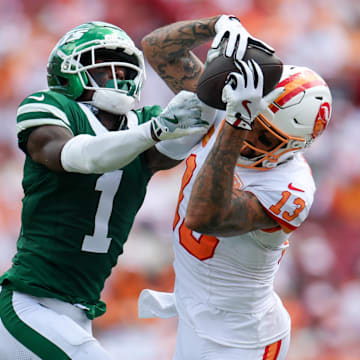 Sep 21, 2025; Tampa, Florida, USA; Tampa Bay Buccaneers wide receiver Mike Evans (13) catches pass defended boy New York Jets cornerback Sauce Gardner (1) in the third quarter at Raymond James Stadium. 