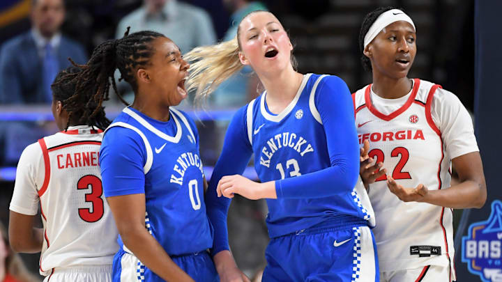 Kentucky Wildcats forward Jordan Obi (0) celebrates with Kentucky Wildcats center Clara Strack (13) Thursday, March 5, 2026, during the SEC Women's Basketball Tournament second round game against the Georgia Bulldogs at Bon Secours Wellness Arena in Greenville, South Carolina.