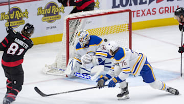 Sep 26, 2024; Ottawa, Ontario, CAN; Ottawa Senators right wing Adam Gaudette (81) scores against Buffalo Sabres goalie Felix Sandstrom (32) in the third period at the Canadian Tire Centre. Mandatory Credit: Marc DesRosiers-Imagn Images