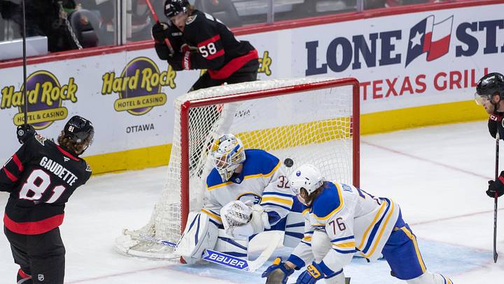 Sep 26, 2024; Ottawa, Ontario, CAN; Ottawa Senators right wing Adam Gaudette (81) scores against Buffalo Sabres goalie Felix Sandstrom (32) in the third period at the Canadian Tire Centre. Mandatory Credit: Marc DesRosiers-Imagn Images