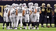 Oct 30, 2022; New Orleans, Louisiana, USA;  Las Vegas Raiders quarterback Jarrett Stidham (3) calls a play in the huddle against the New Orleans Saints during the second half at Caesars Superdome. Mandatory Credit: Stephen Lew-Imagn Images