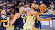 Oct 23, 2025; San Francisco, California, USA;  Golden State Warriors guard Stephen Curry (30) goes up for a shot as Denver Nuggets center Nikola Jokić (15) trails on the play during the third quarter at Chase Center. Mandatory Credit: Bob Kupbens-Imagn Images