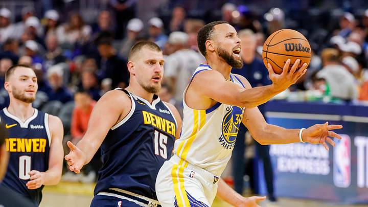 Oct 23, 2025; San Francisco, California, USA;  Golden State Warriors guard Stephen Curry (30) goes up for a shot as Denver Nuggets center Nikola Jokić (15) trails on the play during the third quarter at Chase Center. Mandatory Credit: Bob Kupbens-Imagn Images