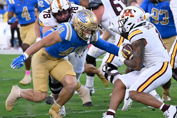 UCLA Bruins linebacker Carson Schwesinger moves to tackle Minnesota Golden Gophers running back Darius Taylor