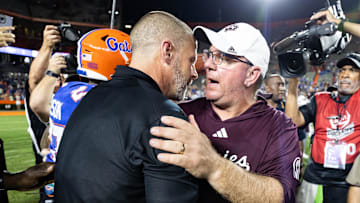 Sep 14, 2024; Gainesville, Florida, USA; Florida Gators head coach Billy Napier and Texas A&M Aggies head coach Mike Elko embrace after the game at Ben Hill Griffin Stadium. Mandatory Credit: Matt Pendleton-Imagn Images