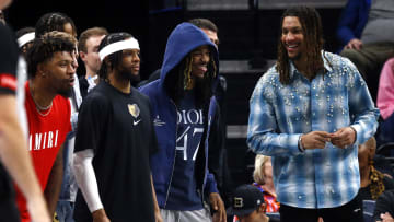 Apr 12, 2024; Memphis, Tennessee, USA; Memphis Grizzlies guard Marcus Smart (left), guard Zavier Simpson (left middle), guard Ja Morant (right middle) and forward Brandon Clarke (right) react from the bench during the second half against the Los Angeles Lakers at FedExForum. 