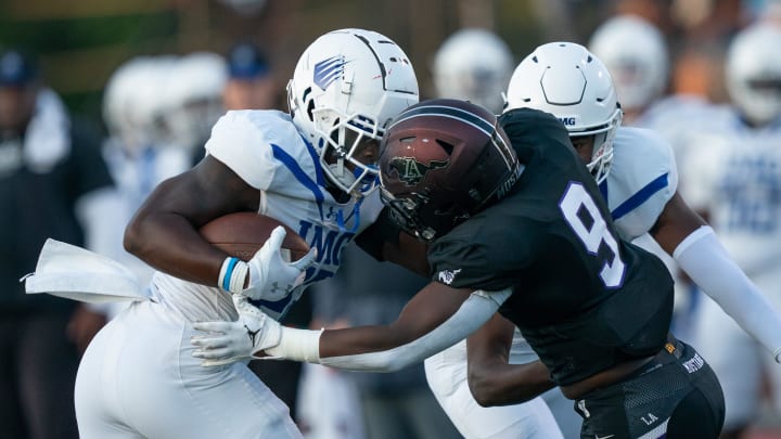 IMG's Jerrick Gibson (22) is met by Lipscomb's Kris Thompson (9) at Lipscomb's Reese Smith Football Field in Nashville, Tenn., Friday night, Aug. 18, 2023. IMG went on to win the game 35-10.