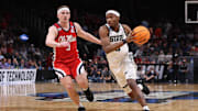 Mar 28, 2025; Atlanta, GA, USA; Michigan State Spartans guard Tre Holloman (5) drives against Mississippi Rebels guard Sean Pedulla (3) in the second half of a South Regional semifinal of the 2025 NCAA tournament at State Farm Arena. Mandatory Credit: Brett Davis-Imagn Images