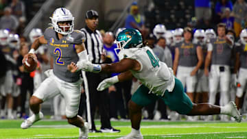 Dec 23, 2023; Honolulu, HI, USA; San Jose State Spartans quarterback Chevan Cordeiro (2) scrambles away from Coastal Carolina Chanticleers defensive lineman Will Whitson (44) during the third quarter of the Easypost Hawaii Bowl at Clarence T.C. Ching Athletics Complex. Mandatory Credit: Steven Erler-Imagn Images