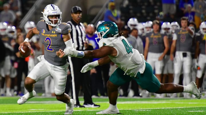 Dec 23, 2023; Honolulu, HI, USA; San Jose State Spartans quarterback Chevan Cordeiro (2) scrambles away from Coastal Carolina Chanticleers defensive lineman Will Whitson (44) during the third quarter of the Easypost Hawaii Bowl at Clarence T.C. Ching Athletics Complex. Mandatory Credit: Steven Erler-Imagn Images