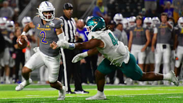 Dec 23, 2023; Honolulu, HI, USA; San Jose State Spartans quarterback Chevan Cordeiro (2) scrambles away from Coastal Carolina Chanticleers defensive lineman Will Whitson (44) during the third quarter of the Easypost Hawaii Bowl at Clarence T.C. Ching Athletics Complex. Mandatory Credit: Steven Erler-Imagn Images