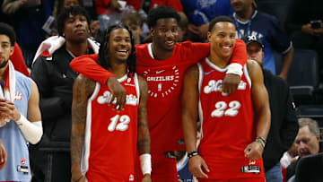 Dec 19, 2024; Memphis, Tennessee, USA; Memphis Grizzlies guard Ja Morant (left), forward Jaren Jackson Jr. (middle) and guard Desmond Bane (right) react during the fourth quarter against the Golden State Warriors at FedExForum. Mandatory Credit: Petre Thomas-Imagn Images