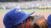 Jul 26, 2024; Toronto, Ontario, CAN; A Toronto Blue Jays hat and glove outside of the dugout during a game against the Texas Rangers at Rogers Centre. Mandatory Credit: John E. Sokolowski-Imagn Images