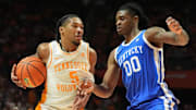 Tennessee's Zakai Zeigler (5) tries to get to the basket while guarded by Kentucky's Otega Oweh (0) during an NCAA college basketball game on Tuesday, Jan. 28, 2025, in Knoxville, Tenn.