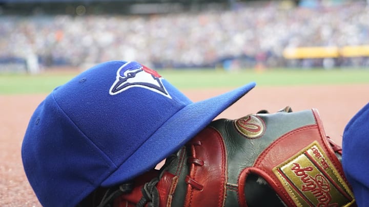 Jul 26, 2024; Toronto, Ontario, CAN; A Toronto Blue Jays hat and glove outside of the dugout during a game against the Texas Rangers at Rogers Centre. Mandatory Credit: John E. Sokolowski-Imagn Images Jul 26, 2024; Toronto, Ontario, CAN; A Toronto Blue Jays hat and glove outside of the dugout during a game against the Texas Rangers at Rogers Centre. Mandatory Credit: John E. Sokolowski-Imagn Images