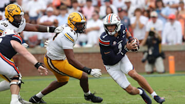 Sep 7, 2024; Auburn, Alabama, USA;  Auburn Tigers quarterback Payton Thorne (1) scrambles from California Golden Bears defenders during the third quarter at Jordan-Hare Stadium. Mandatory Credit: John Reed-Imagn Images
