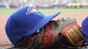 Jul 26, 2024; Toronto, Ontario, CAN; A Toronto Blue Jays hat and glove outside of the dugout during a game against the Texas Rangers at Rogers Centre. Mandatory Credit: John E. Sokolowski-Imagn Images