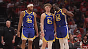 Apr 30, 2025; Houston, Texas, USA; Golden State Warriors forward Draymond Green (23) talks to guard Brandin Podziemski (2) and guard Moses Moody (4) before playing against the Houston Rockets in the second quarter during game five of first round for the 2025 NBA Playoffs at Toyota Center. Mandatory Credit: Thomas Shea-Imagn Images