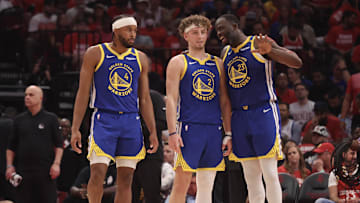 Apr 30, 2025; Houston, Texas, USA; Golden State Warriors forward Draymond Green (23) talks to guard Brandin Podziemski (2) and guard Moses Moody (4) before playing against the Houston Rockets in the second quarter during game five of first round for the 2025 NBA Playoffs at Toyota Center. Mandatory Credit: Thomas Shea-Imagn Images
