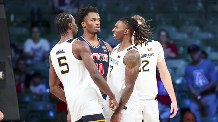 Nov 29, 2024; Paradise Island, Bahamas, BHS;  West Virginia Mountaineers guard Toby Okani (5) and West Virginia Mountaineers guard Javon Small (7) celebrate in front of Arizona Wildcats forward Tobe Awaka (30) during overtime at Imperial Arena at the Atlantis resort.  Mandatory Credit: Kevin Jairaj-Imagn Images