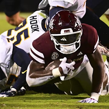 Mississippi State Bulldogs running back Johnnie Daniels falls short of the endzone while defended by Toledo Rockets linebacker Jackson Barrow during the fourth quarter at Davis Wade Stadium at Scott Field.