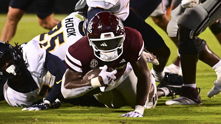 Mississippi State Bulldogs running back Johnnie Daniels falls short of the endzone while defended by Toledo Rockets linebacker Jackson Barrow during the fourth quarter at Davis Wade Stadium at Scott Field.