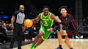 Nov 27, 2024; Las Vegas, Nevada, USA; Oregon Ducks guard TJ Bamba (5) dribbles against San Diego State Aztecs guard Miles Byrd (21) during the first half at MGM Grand Garden Arena. Mandatory Credit: Stephen R. Sylvanie-Imagn Images