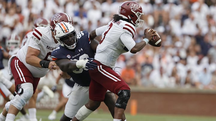 Sep 2, 2023; Auburn, Alabama, USA; Auburn Tigers defensive lineman Jayson Jones (99) tackles Massachusetts Minutemen quarterback Taisun Phommachanh (3) during the third quarter at Jordan-Hare Stadium. Mandatory Credit: John Reed-Imagn Images Sep 2, 2023; Auburn, Alabama, USA; Auburn Tigers defensive lineman Jayson Jones (99) tackles Massachusetts Minutemen quarterback Taisun Phommachanh (3) during the third quarter at Jordan-Hare Stadium. Mandatory Credit: John Reed-Imagn Images