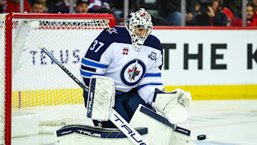 Nov 15, 2025; Calgary, Alberta, CAN; Winnipeg Jets goaltender Connor Hellebuyck (37) makes a save against the Calgary Flames during the second period at Scotiabank Saddledome. Mandatory Credit: Sergei Belski-Imagn Images