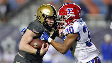 Louisiana Tech's Alonzo Jackson Jr. tries to tackle Army's Bryson Daily during the 2024 Independence Bowl.