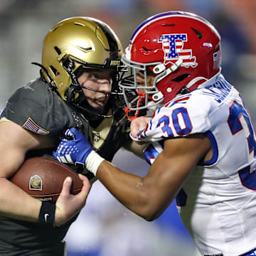 Louisiana Tech's Alonzo Jackson Jr. tries to tackle Army's Bryson Daily during the 2024 Independence Bowl.