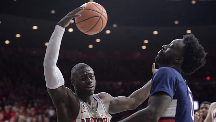 Dec 21, 2017; Tucson, AZ, USA; Arizona Wildcats guard Rawle Alkins (1) loses control of the ball as Connecticut Huskies guard Antwoine Anderson (0) defends during the second half at McKale Center. Mandatory Credit: Casey Sapio-Imagn Images