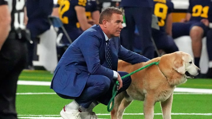 Jan 8, 2024; Houston, TX, USA; ESPN analyst Kirk Herbstreit walks his dog Ben before the 2024 College Football Playoff national championship game between the Michigan Wolverines and the Washington Huskies at NRG Stadium. Mandatory Credit: Kirby Lee-USA TODAY Sports